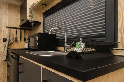 a kitchen with a sink and a window at Aurora Green Hill in Podobin
