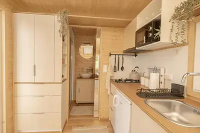 a kitchen with white cabinets and a sink at Aurora Green Hill in Podobin