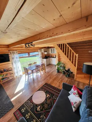 a living room with a couch and a table at Domki Na Grapie - z widokiem na Tatry in PyzÃ³wka