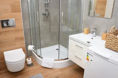 a bathroom with a shower and a toilet and a sink at Apartamenty Legionów 30 in Oświęcim