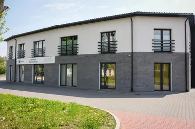 a large building with windows on a street at Apartamenty Legionów 30 in Oświęcim
