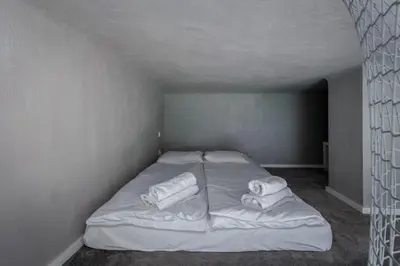 a white bed in a room with towels on it at Parkside Fresh Apartments - Old Town Guesthouse - by Upstairs in Kraków