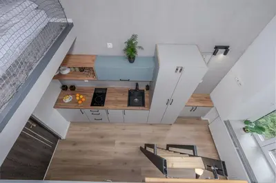 an overhead view of a kitchen in a loft at Parkside Fresh Apartments - Old Town Guesthouse - by Upstairs in Kraków