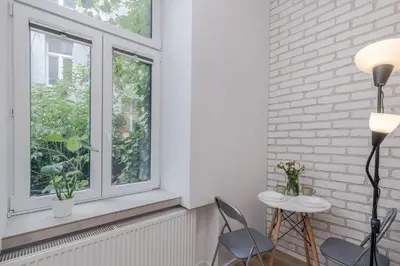 a room with two chairs and a window at Parkside Fresh Apartments - Old Town Guesthouse - by Upstairs in Kraków