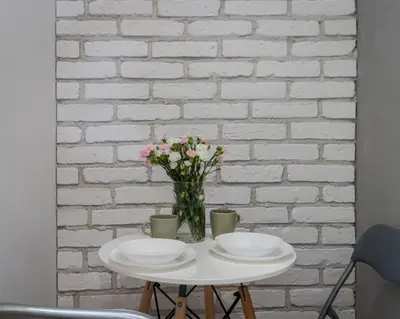 a table with two plates and a vase of flowers at Parkside Fresh Apartments - Old Town Guesthouse - by Upstairs in Kraków
