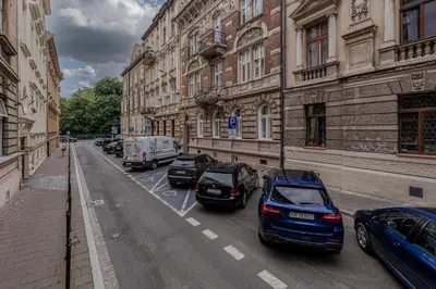 a row of cars parked on a street next to buildings at Parkside Fresh Apartments - Old Town Guesthouse - by Upstairs in Kraków