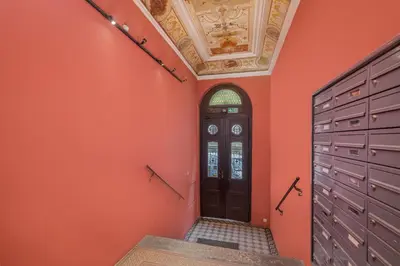 a room with orange walls and a door and a ceiling at Parkside Fresh Apartments - Old Town Guesthouse - by Upstairs in Kraków