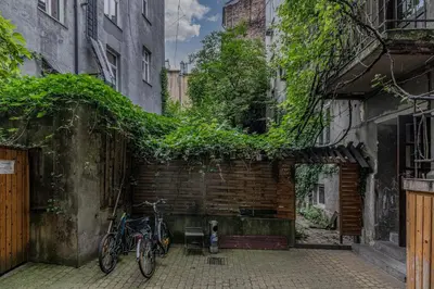 two bikes parked next to a brick wall with ivy at Parkside Fresh Apartments - Old Town Guesthouse - by Upstairs in Kraków