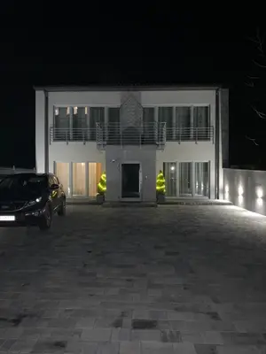 a car parked in front of a building at night at Apartamenty in Miechów