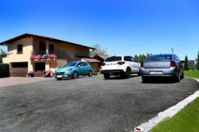 a group of cars parked on the side of a road at Domek pod Zatorem in Ryczów