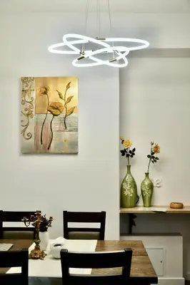 a dining room with a table and a ceiling fan at Goldengreen Apartment in Kraków