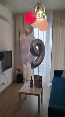 a living room with balloons and a coffee table at Apartamenty Vulcan in Zator