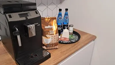 a counter with a coffee maker and a coffeemaker at Apartamenty Vulcan in Zator