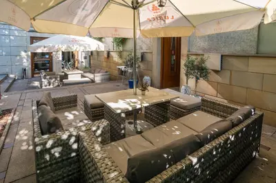 a restaurant with tables and chairs and umbrellas at Blue Swan in Kraków