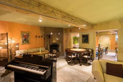 a living room with a piano and a dining room at Blue Swan in Kraków