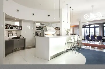 a kitchen with a bar with stools in it at Blue Swan in Kraków