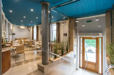 a dining room with a blue ceiling at Blue Swan in Kraków