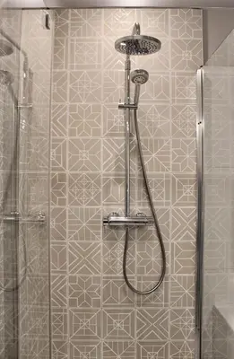 a shower with a shower head in a bathroom at Hotel Perła in Kraków