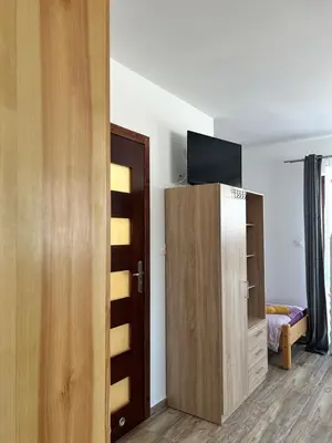 a room with a tv on top of a cabinet at Ranczo Zwierzyniec Noclegi in Jordanów