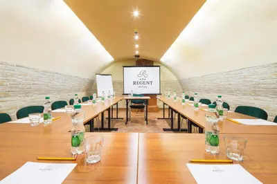 a conference room with a long table with wine bottles at Hotel Regent in Kraków