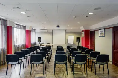 a room with rows of chairs and a whiteboard at Hotel Galicya in Kraków