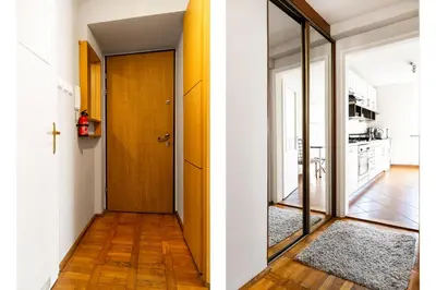 a hallway with a door and a cross on the wall at 2 Bedroom Apartment, Heart of Krakow Tomasza st in Kraków