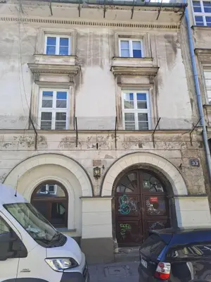 two cars parked in front of a building at 2 Bedroom Apartment, Heart of Krakow Tomasza st in Kraków