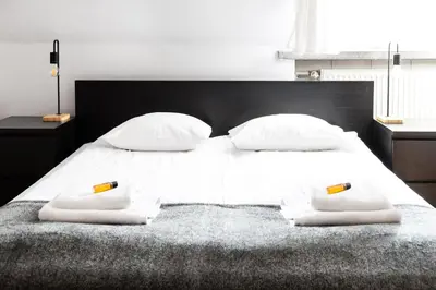 a bedroom with a white bed with two towels on it at 2 Bedroom Apartment, Heart of Krakow Tomasza st in Kraków
