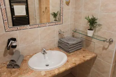 a bathroom with a sink and a mirror at DReAM Post Aparthotel in Kraków