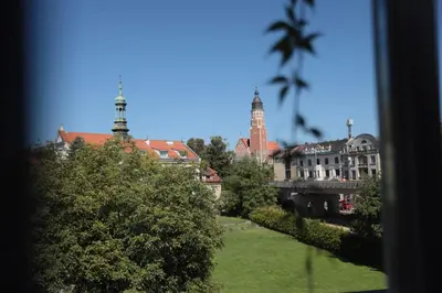a view of a city with a clock tower and buildings at DReAM Post Aparthotel in Kraków