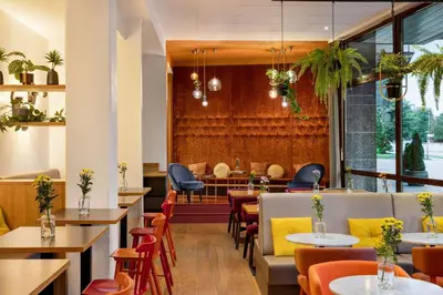 a restaurant with tables and chairs and a dining room at Vienna House Easy by Wyndham Cracow in Kraków