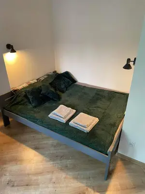 a bed in a room with two towels on it at Daszyńskiego 7m3 in Kraków