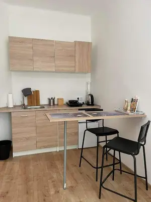a kitchen with a table and chairs in a room at Daszyńskiego 7m3 in Kraków