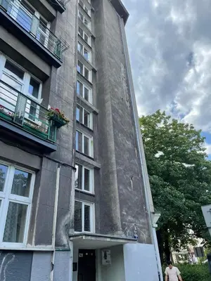 a tall building with a clock on the side of it at Daszyńskiego 7m3 in Kraków