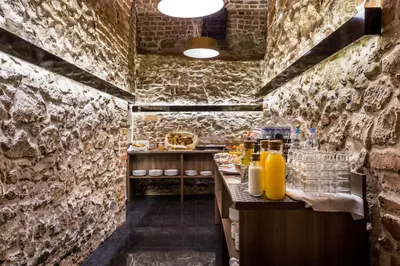 a kitchen with a counter with drinks on it at Hotel Elektor Premium in Kraków