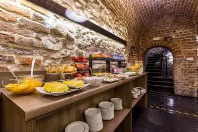a buffet line with plates of food on it at Hotel Elektor Premium in Kraków