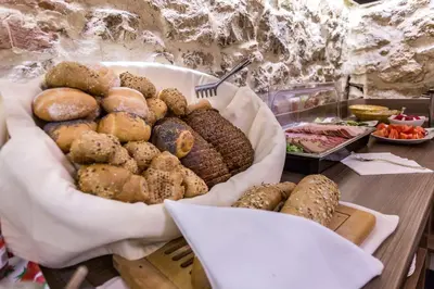 a basket of bread and pastries on a table at Hotel Elektor Premium in Kraków