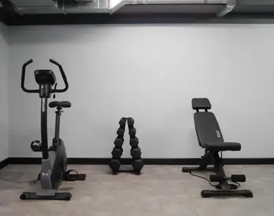 two exercise bikes sitting next to a white wall at Hotel Wyspiański in Kraków