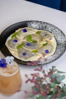 a plate of food with a dessert on a table at Hotel Atrium in Kraków