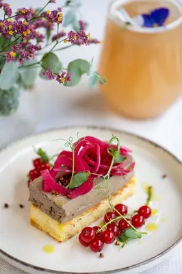 a plate with a piece of food on a table at Hotel Atrium in Kraków