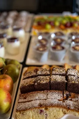 a display ofbrownies and apples and other pastries at Hotel Atrium in Kraków