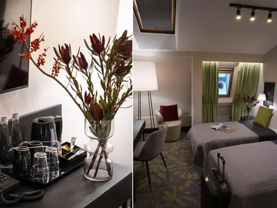a hotel room with a bed and a vase of flowers at Hotel Atrium in Kraków