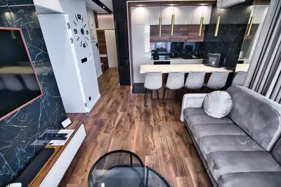 a living room with a couch and a kitchen at Boutique 78 by Housine in Zator