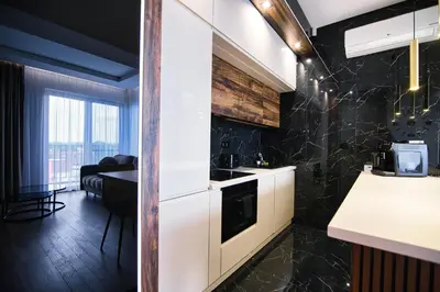 a kitchen with white cabinets and a black wall at Boutique 78 by Housine in Zator