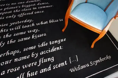 a letter with a blue chair on a blackboard at Hotel Senacki in Kraków