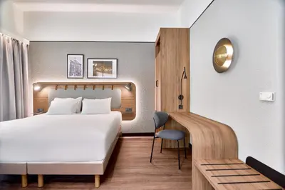 a hotel room with a bed and a desk at CAMPANILE PRIME Krakow Old Town in Kraków