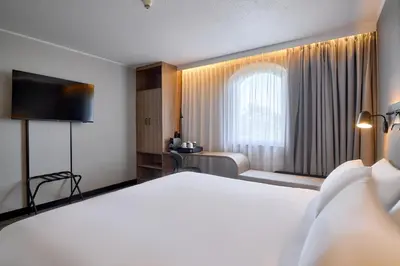 a hotel room with a bed and a window at CAMPANILE PRIME Krakow Old Town in Kraków