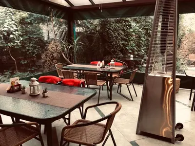 an outdoor patio with two tables and chairs at Hotel City SM Business & Spa in Kraków