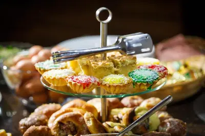 a display of cupcakes and pastries on a plate at Hotel City SM Business & Spa in Kraków