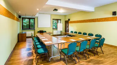 a conference room with a long table and chairs at Hotel City SM Business & Spa in Kraków